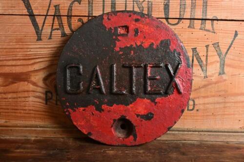 CALTEX: A cast metal Caltex petrol station tank cover plate, 25.5cm diameter
