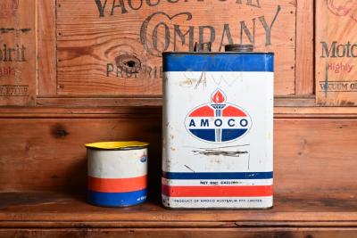 AMOCO: Two Amaco tins, a one gallon with 'chain saw' scratched into it and a 500 gram grease tin