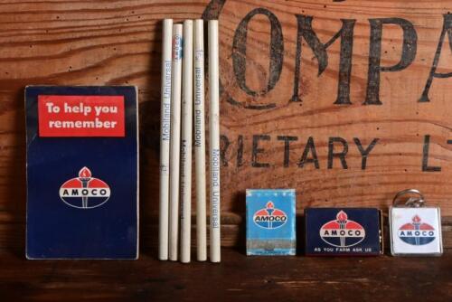 AMOCO: A collection of Amoco items including unused pencils, matches, key ring and used notebook