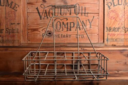 BOTTLE RACK: A vintage wire oil bottle rack for eight bottles, 42cm high