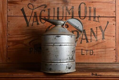 CAN: An early Australian embossed one/two gallon Rega tin with cap and pourer, 22.5cm high