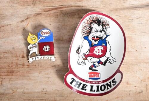 AFL/LIONS: A circa 2000s&nbsp;Esso 'Drop Man'&nbsp;Lions enamel badge by Bertram together with a 1970s VFL 'The Lions' unused sticker