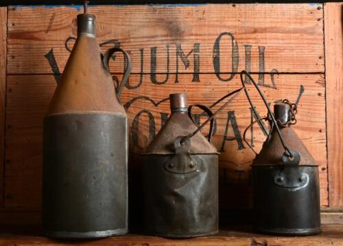 OIL CANS: Three early rustic tin oil cans, largest 34cm high