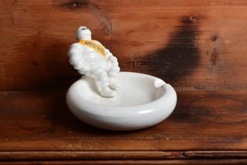 MICHELIN: A decorative modern ceramic change tray/ashray featuring a seated Bibendum to rim, 10cm high, 12.5cm diameter