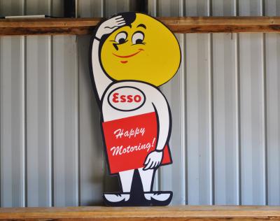 ESSO: A mid 20th century "Esso Happy Motoring" foam core sign featuring drip man, 104 x 49cm