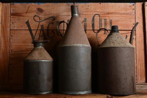 OIL CANS: Three early rustic tin oil cans, largest 34cm high