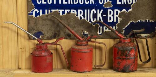 OILERS: A set of three graduated red painted oilers, the tallest 18cm high