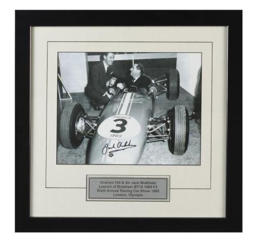 BRABHAM: A black and white image of Sir Jack Brabham and Graham Hill at the launch of the Brabham BT15 1965 F3, as took place at the sixth Annual Racing Car Show 1965 London, Olympia. Image signed by Sir Jack Brabham