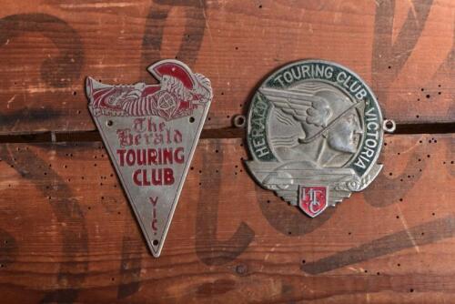 HERALD TOURING CLUB: Two Herald Touring Club Victoria badges. STOKES MELBOURNE 'HERALD TOURING CLUB VICTORIA' badge & 'The Herald TOURING CLUB VIC' triangular badge numbered '502'