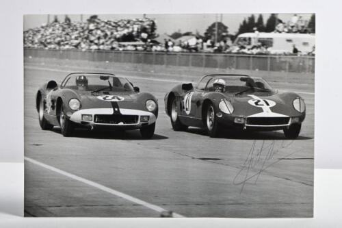 FERRARI/SURTEES: A black and white image by Dave Friedman of the winning Ferrari 275 P of Mike Parkes/Umberto Maglioli in the 1964 12 Hours of Sebring with the number 21 Ferrari 330P of John Surtees/Lorenzo Bandini. John Surtees signature