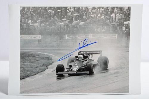 ANDRETTI: A black and white image of Mario Andretti racing the Lotus 77 at the 1976 Japanese Grand Prix. Andretti signature