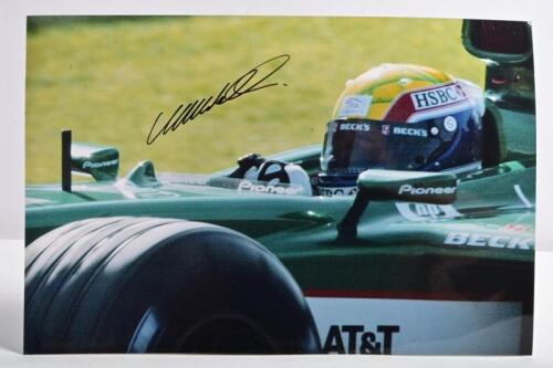 WEBBER: A colour picture of Mark Webber driving the Jaguar R4 Formula 1 car. Picture hand signed in black marker by Webber