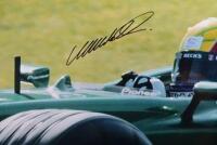 WEBBER: A colour picture of Mark Webber driving the Jaguar R4 Formula 1 car. Picture hand signed in black marker by Webber - 2
