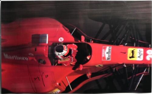 BERGER: A laminated poster depicting Gerhard Berger driving a Ferrari Formula 1 car. Gerhard Berger signature