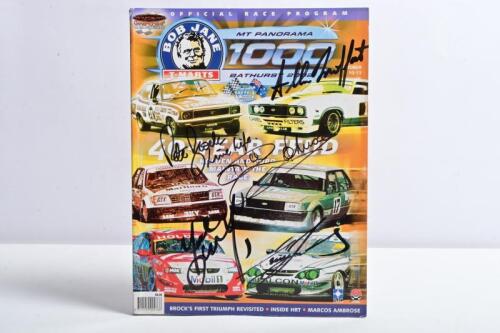 BATHURST: A 'MT PANORAMA 1000 BATHURST 2002 OFFICIAL RACE PROGRAM'. Front cover signed by Peter Brock, Dick Johnson, Craig Lowndes, Allan Moffat, Mark Skaife