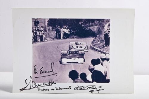 TARGA FLORIO: A black and white image from the 1971 Targa Florio of Andrea de Adamich/Gijs van Lennep racing a Alfa Romeo T33-3 with Vic Elford/Gerard Larrousse following in a Porsche 908/3. Image with all four driver signatures