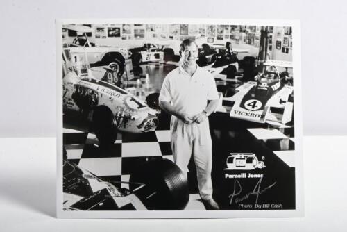 PARNELLI JONES: A black and white picture by Bill Cash of Parnelli Jones standing in the Parnelli Jones museum. Parnelli Jones signature