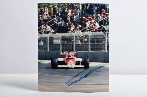 LAUDA: A colour picture of Niki Lauda racing the McLaren MP4/2B (Tag Turbo) at the 1985 Australian Grand Prix, Adelaide. Lauda signature