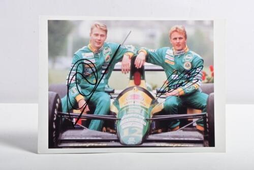 HAKKINEN/HERBERT: A classic colour image of Mika Hakkinen and Johnny Herbert sitting on a Lotus 102D. Picture signed by Mika Hakkinen and Johnny Herbert