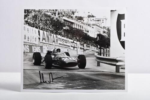 AMON: A superb black and white picture of Chris Amon racing a Ferrari 312 at the Monte Carlo Grand Prix, Monaco 1967. Chris Amon signature