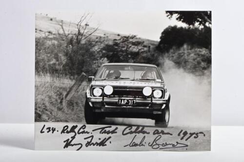 BOND/FIRTH: A black and white picture of Colin Bond and Harry Firth testing a Holden Torana L34 Rally Car at Calder Park testing area, 1975. Harry Firth & Colin Bond signatures