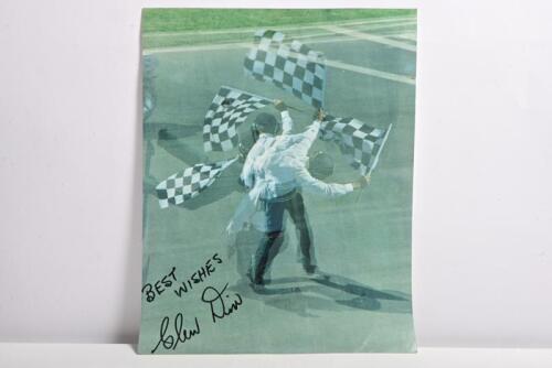 DIX: A colour picture of Glen Dix in a full range of chequered flag waving. Glen Dix signature
