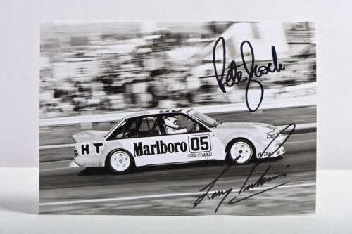 BROCK/PERKINS: A black and white Ian Smith picture of the 1984 HDT VK Holden Commodore as raced by Peter Brock and Larry Perkins. Brock & Perkins signatures