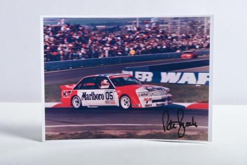 BROCK: A colour picture of Peter Brock racing a HDT VK Holden Commodore at Bathurst. Picture signed by Peter Brock. Circa 1984