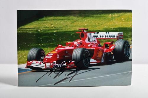 SCHUMACHER: A colour picture of Michael Schumacher racing a Ferrari F2004 at the 2004 Australian Grand Prix, Melbourne. Michael Schumacher signature
