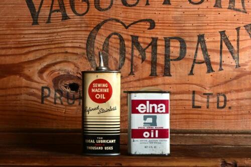 SEWING MACHINE OIL: Two four fluid ounce sewing machine oil tins, including Elna
