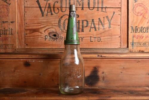 CASTROL: A 1940/50s embossed "Castrol Wakefield" one imperial quart oil bottle with green painted tin pourer and dust cap