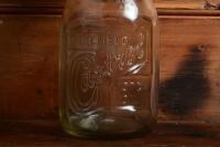 CASTROL: A 1940/50s embossed "Castrol Wakefield" one imperial quart oil bottle with green painted tin pourer and dust cap - 2
