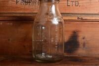 CASTROL: A 1940/50s embossed "Castrol Wakefield" one imperial quart oil bottle with green painted tin pourer and dust cap - 5