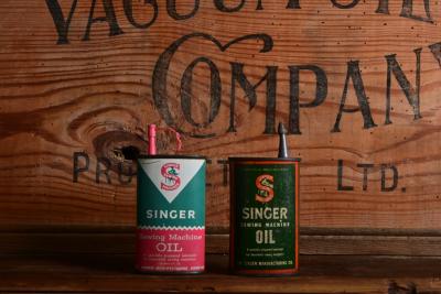 SINGER: Two three fluid ounce "Singer" sewing machine oil tins