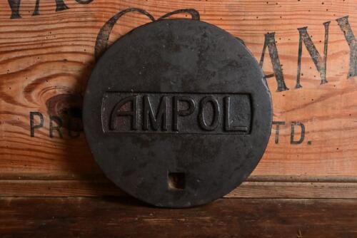 AMPOL: An Ampol cast iron petrol station take cover, 19.5cm diameter