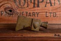 SHELL: A rare and early brass embossed hammer head for drum opening, 14.5cm wide