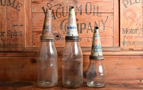 MOBIL: An imperial pint and two imperial quart oil bottles with circa 1950s "Mobiloil" tin pourers