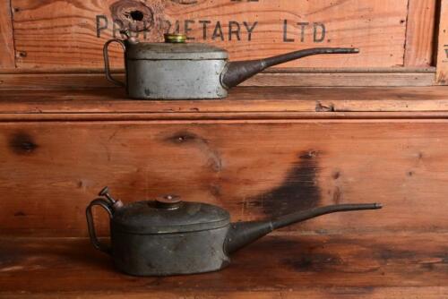 REGA: A pair of galvanised steel embossed "Rega" half pint oil cans, each 30cm long