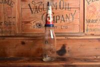 TEXACO: A mid 20th century "Texaco" embossed one quart oil bottle, with original mid 20th century "Texaco 40" tin pourer and dust cover, with rivet air hole