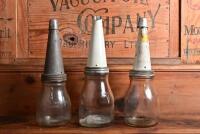 OIL POURERS: A half litre and two pint oil bottles with tin pourers, including Shell