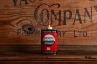 NECCHI: An original American "Necchi Sewing Machine" three fluid ounce oil tin, with contents