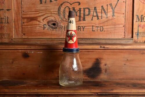 TEXACO: A mid 20th century "Texaco" embossed one pint oil bottle, with original mid 20th century "Texaco 40" tin pourer and dust cover, with rivet air hole