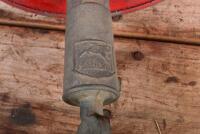 VACUUM OIL CO: A red painted unbranded petrol can with a circa 1930s Mobiloil tap, together with a a copper painted oil can, largest 41cm high - 3