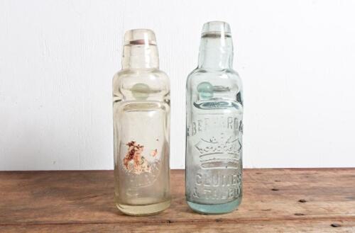 LEMONADE BOTTLES: Two embossed Codd marble lemonade bottles, "Eberhard & Co, Clunes and Talbot" and "J Hatterley, Yackandandah", 18cm high