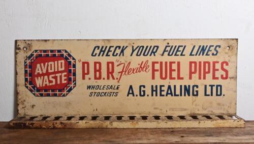 FUEL PIPES: A vintage point of sale display tin sign for "PBR Flexible Fuel Pipes", with slotted shelf for displaying pipes, 23 x 61cm