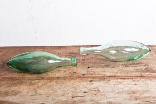 ROSS'S: An antique embossed "Ross's, Belfast" Hamilton (Torpedo)" green glass bottle and another unmarked bottle, longest 25cm