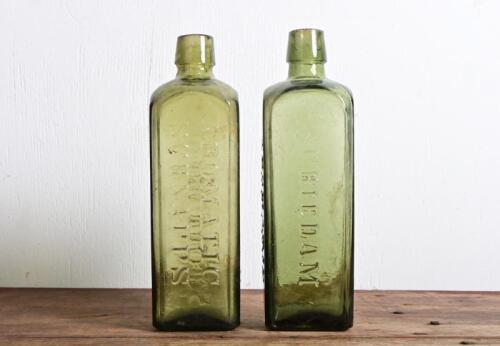 SCHNAPPS: Two antique embossed" Ulpho Wolfe's Schiedam, Aromatic Schnapps' ring seal dark green bottles, 19cm high