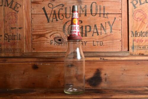 SHELL: A one quart oil bottle, with 1950/60s "Shell X-100 Motor Oil" tin pourer and dust cover