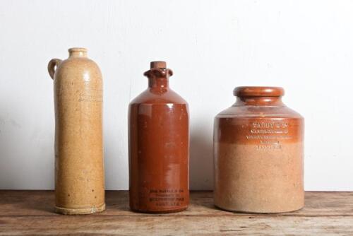 STONEWARE VESSELS: Three antique stoneware vessels, comprising a tobacco jar, ink bottle and a Dutch handled bottle, the tallest 28cm high