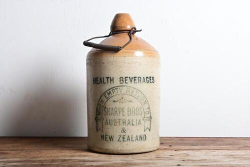 SHARPE BROS: An antique "Sharpe Bros, Health Beverages" five gallon stoneware jar with wire handle, 33cm high